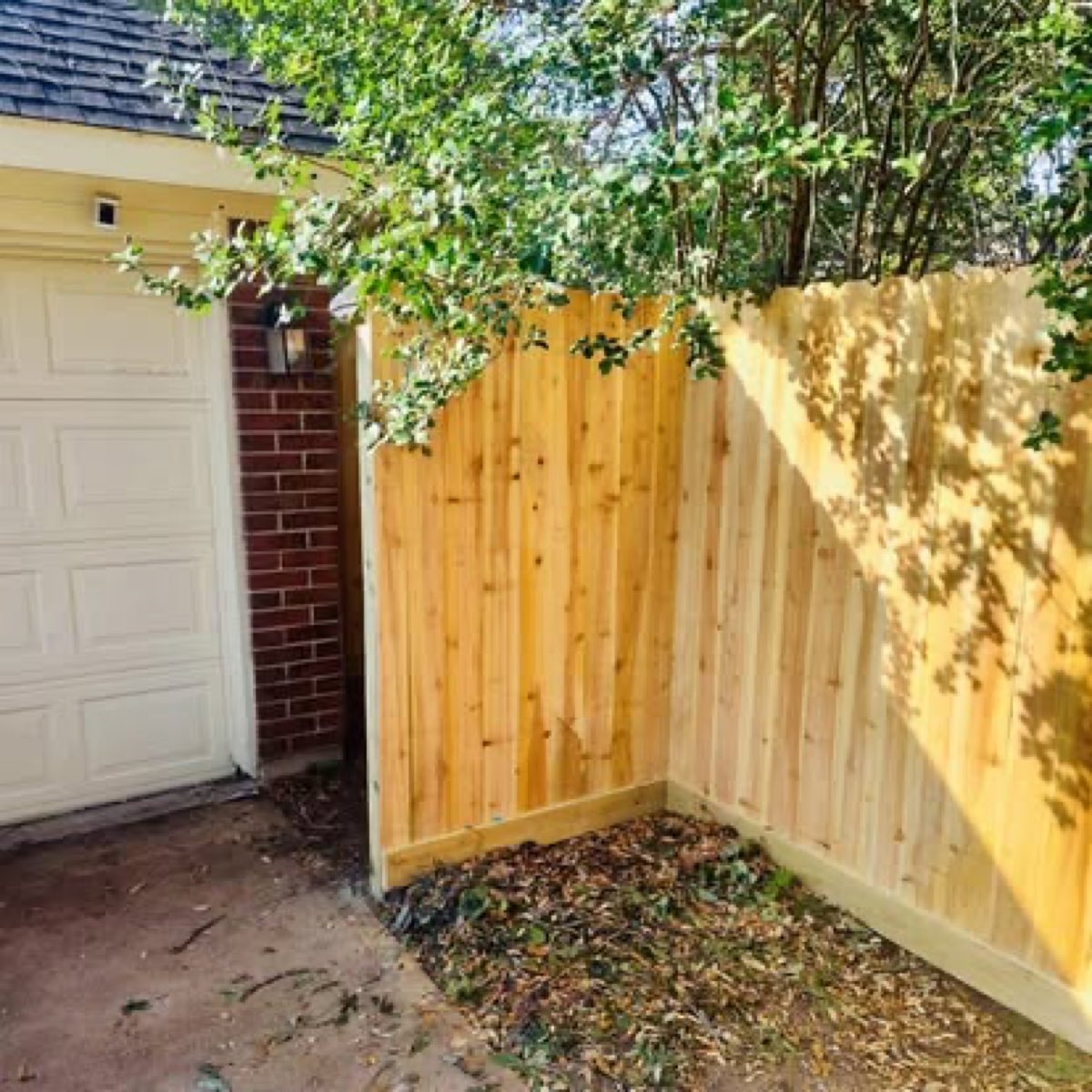 Cedar privacy fence at a garage corner